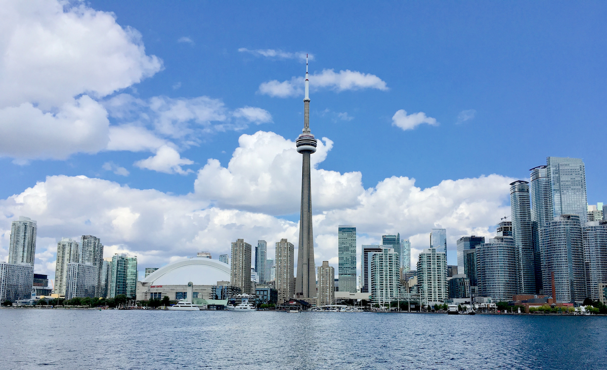 A picture of Toronto skyline on a sunny day with blue sky and clouds